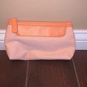 Orange Estée Lauder travel bag